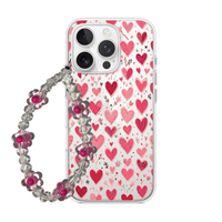 Clear phone case featuring small sketched pink and red hearts with a matching flower bead wrist charm.