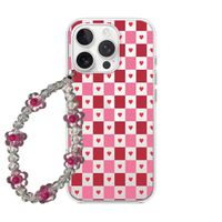 Clear phone case with a red and pink checkerboard pattern containing mini hearts, paired with a flower bead wrist strap.