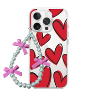 Clear phone case with large bold red hearts and black outlines, attached to a pearl wrist strap with pink bows.