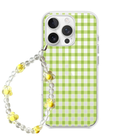 Clear phone case with a dark green gingham pattern and a matching clear and green floral beaded phone strap.
