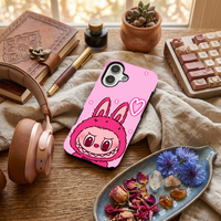 Glossy phone case featuring a hot pink Labubu monster character and a glowing neon heart outline, placed on an aesthetic wooden desk setup.