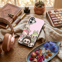 Glossy phone case featuring a group of colorful Labubu monsters clustered together on a light pink background, placed on a textured fabric.