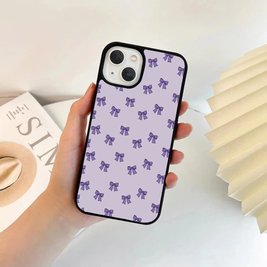 Lavender phone case featuring a repeating pattern of small, solid dark purple bows.