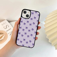 Lavender phone case featuring a repeating pattern of small, solid dark purple bows.