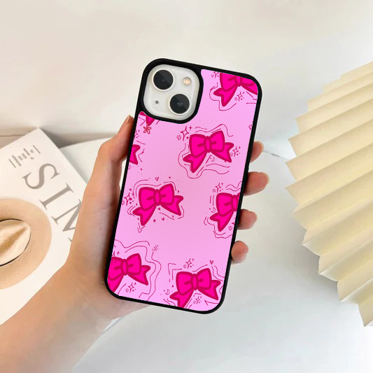 Bright hot pink phone case with a pattern of darker pink chunky bows and hand-drawn sparkle accents.