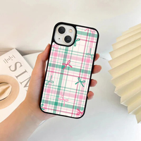 Phone case featuring a pastel pink, teal, and white plaid pattern with scattered small pink and teal bows.