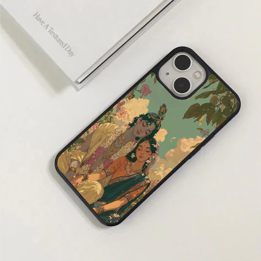 Elegant phone case showing a beautifully painted portrait of Radha and Krishna sitting peacefully under a leafy tree with a cloudy sky.