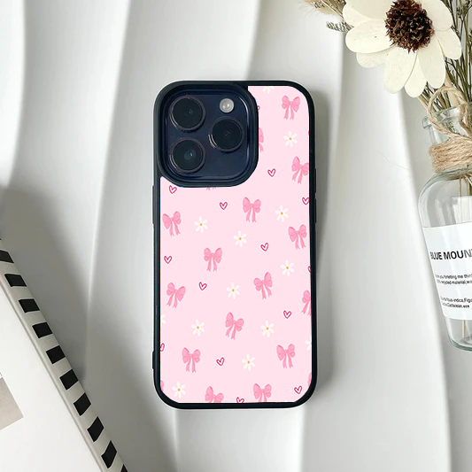 Protective phone case featuring a light pink background with scattered pink bows, white daisies, and tiny pink hearts.