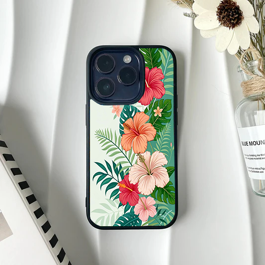 Tropical themed phone case with pink and orange hibiscus flowers and green monstera leaves on a light background.
