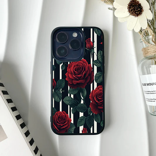 Phone case featuring realistic dark red roses and leaves over a black and white vertical striped background.