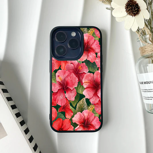 Phone case completely covered in a dense pattern of bright pink hibiscus flowers and dark green leaves.