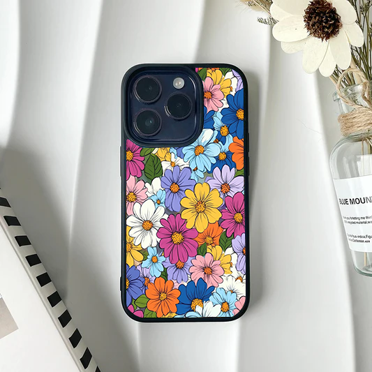 Phone case covered edge-to-edge in tightly packed colorful daisies in pink, blue, purple, yellow, and white.