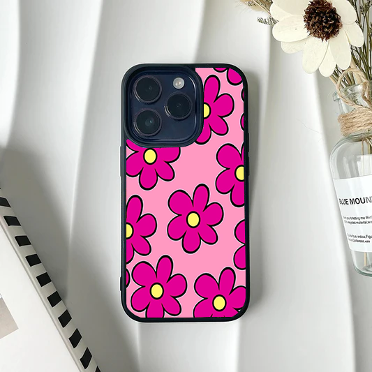 Bright pink phone case featuring large, stylized Y2K-style hot pink flowers with yellow centers and black outlines.