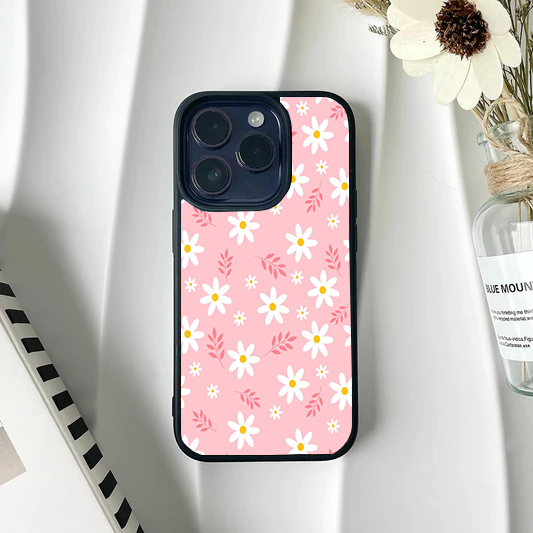 Soft pink phone case patterned with white daisies and small pink leafy sprigs.