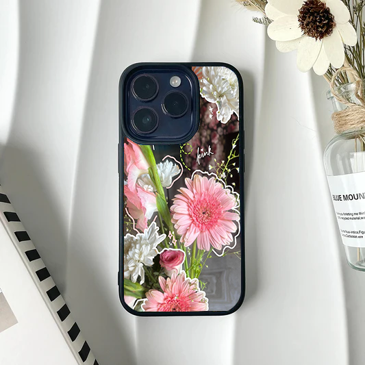 Phone case featuring a photograph of pink and white flowers accented with hand-drawn white doodle outlines.