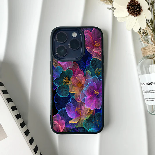 Dark phone case featuring a glowing, translucent x-ray style floral pattern in neon pink, purple, and blue.