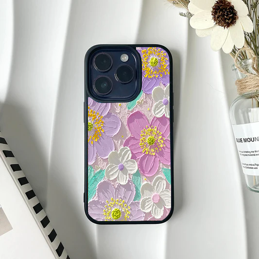 Phone case with a faux-textured impasto painting design of pastel purple, pink, and white flowers.
