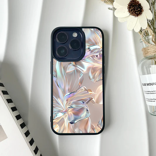 Phone case featuring an abstract, 3D-rendered floral design that looks like iridescent, flowing liquid metal in pink and silver hues.