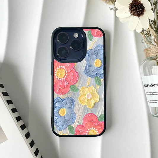Phone case with a thick textured impasto painting design of colorful pink, blue, and yellow flowers.