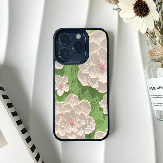 Phone case featuring a faux-textured impasto painting design of large white flowers on a bright green background.