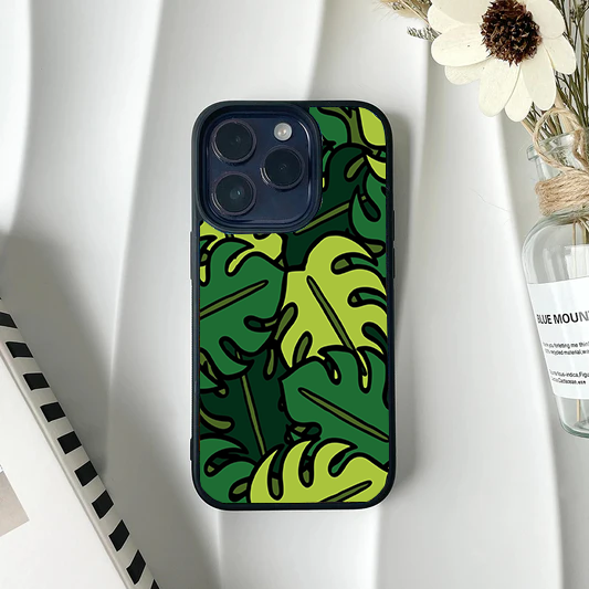 Phone case featuring a bold, graphic pattern of green monstera leaves with heavy black outlines.