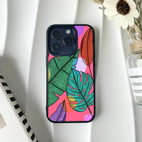 Phone case featuring detailed, hand-sketched colorful tropical leaves over a vibrant pink abstract background.