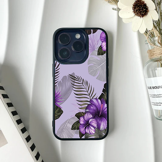 Soft lavender phone case featuring an elegant tropical arrangement of purple hibiscus flowers and mixed green and grey palm leaves