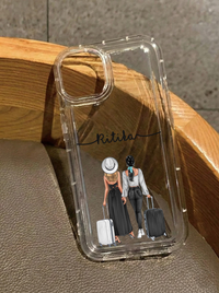 Clear iPhone 16 case displaying an illustration of two girls from behind walking with rolling suitcases, customized with the name Ritika in black script.